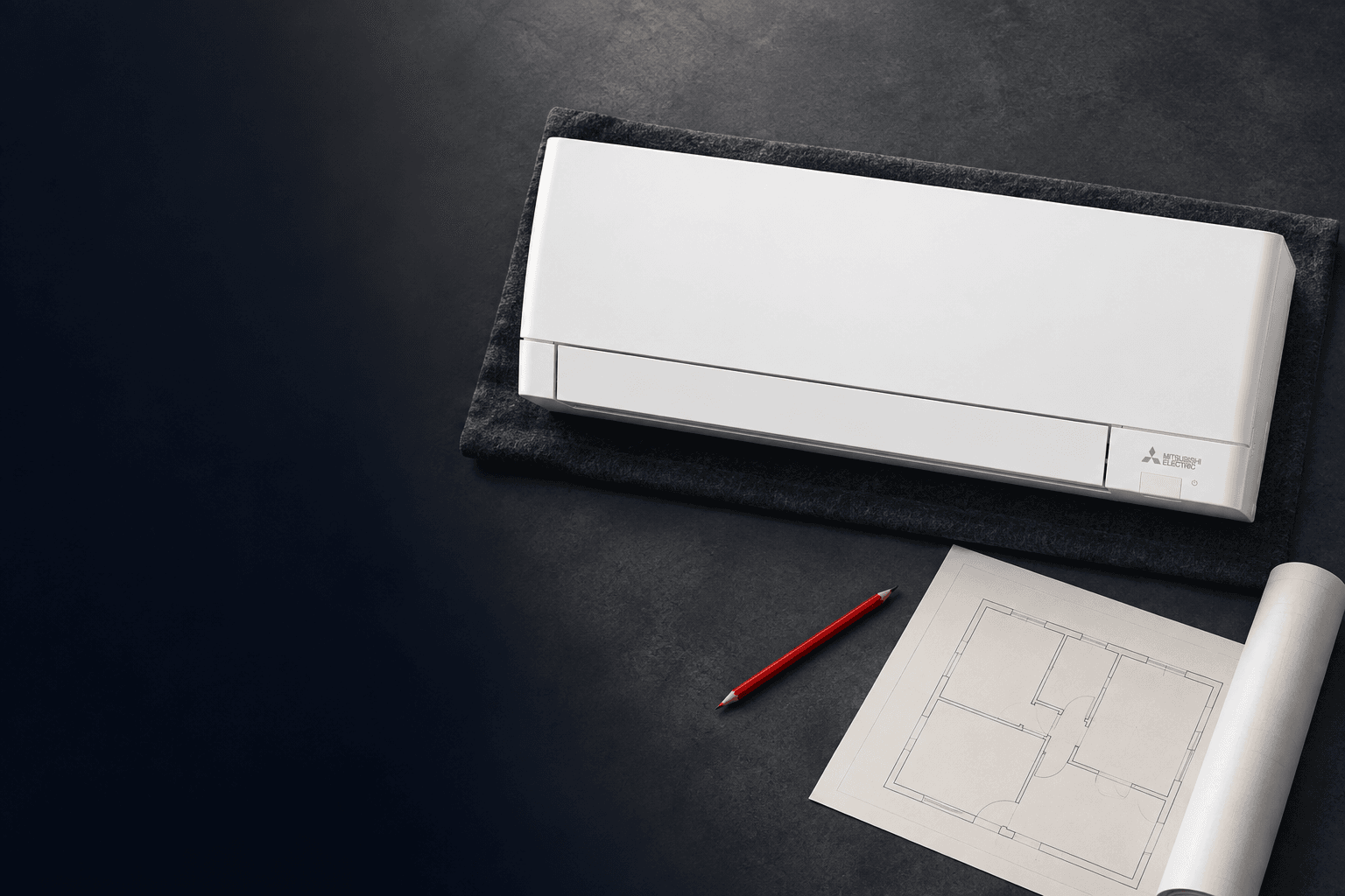 Unidad interior Mitsubishi Electric junto a un plano, ilustración de la planificación de instalación en Las Tablas